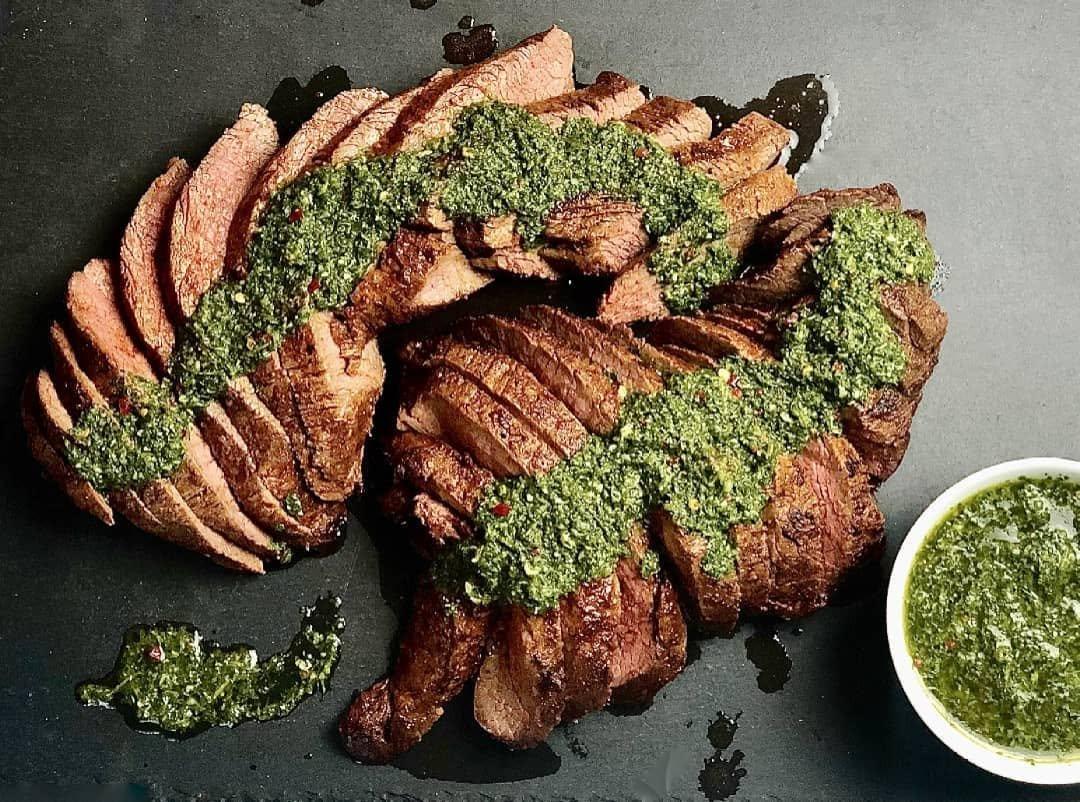 Sliced steak with chimichurri