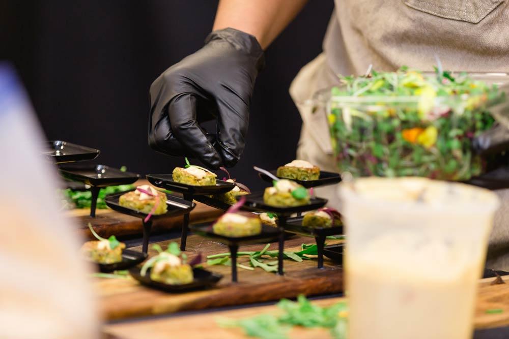 A chef finishing plates at an event