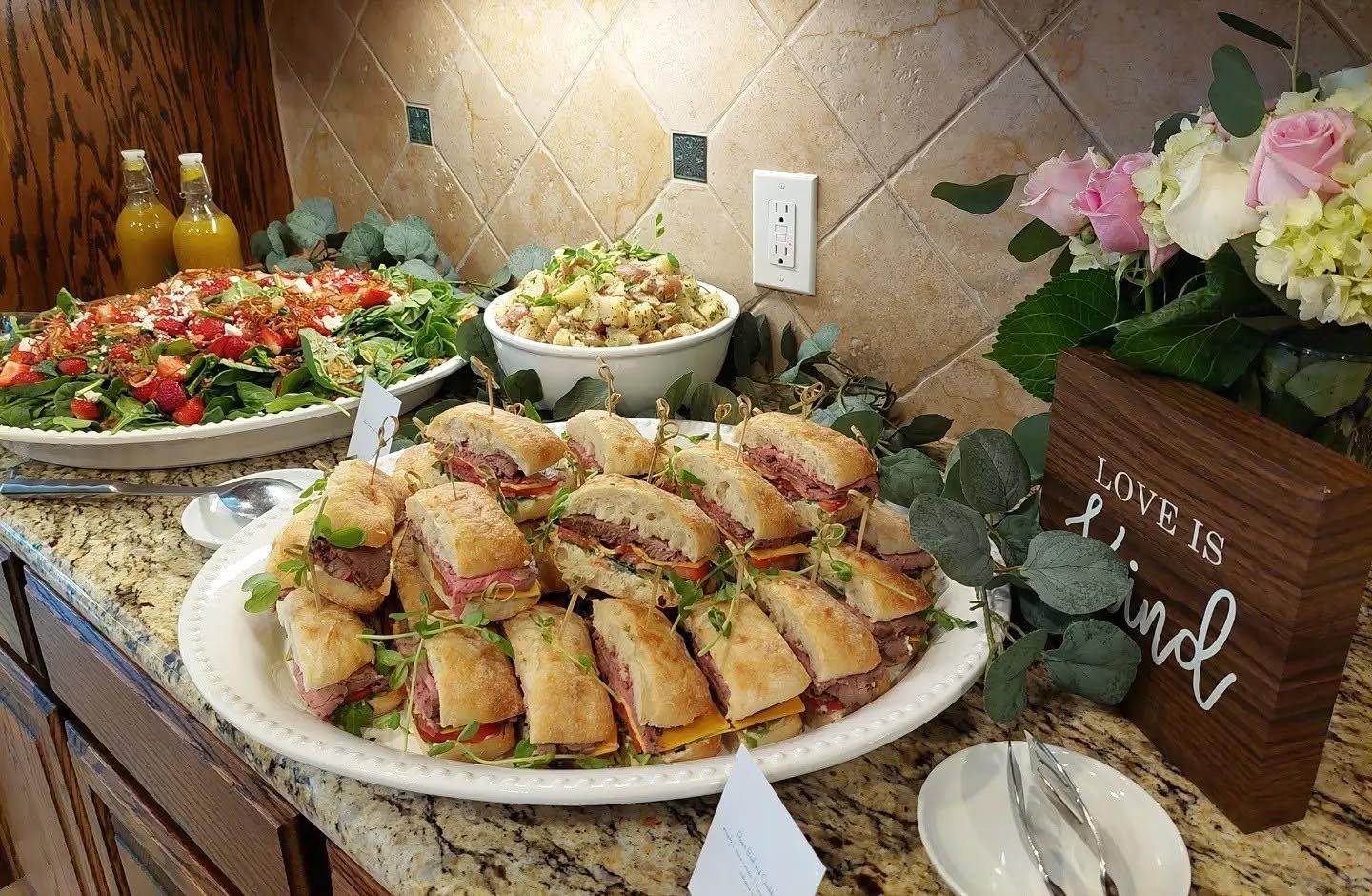 A sandwich platter and salads set for a working lunch